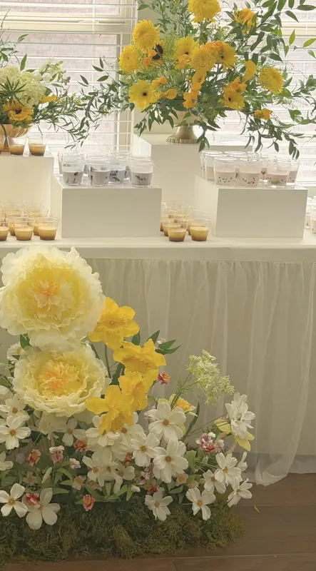Sunshine yellow — paper peonies, daffodils & cosmos at a first-birthday table